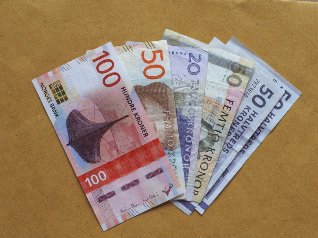 An assortment of international banknotes fanned out, representing the ability to hold multiple currencies at once